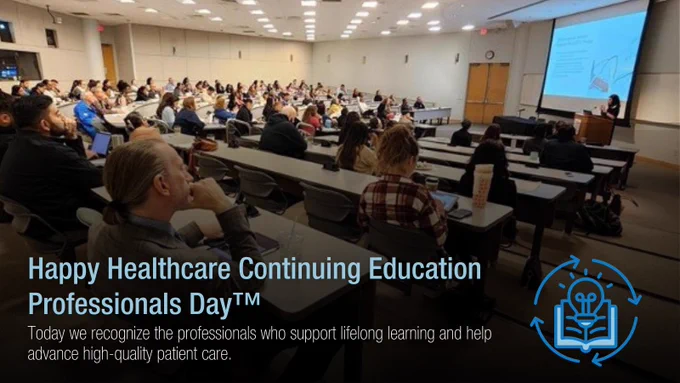 An educational seminar for healthcare professionals in progress, with a presenter speaking in front of a large audience in an auditorium. The presentation slide reads 'Happy Healthcare Continuing Education Professionals Day™'.
