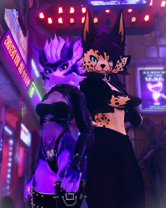 A low shot of two vrchat avatars in a futuristic cyberpunk map. On the left, a purple nardoragon girl wearing fishnets and a punk outfit. On the right, a cheetah wearing black sweatpants and a crop top jacket.
