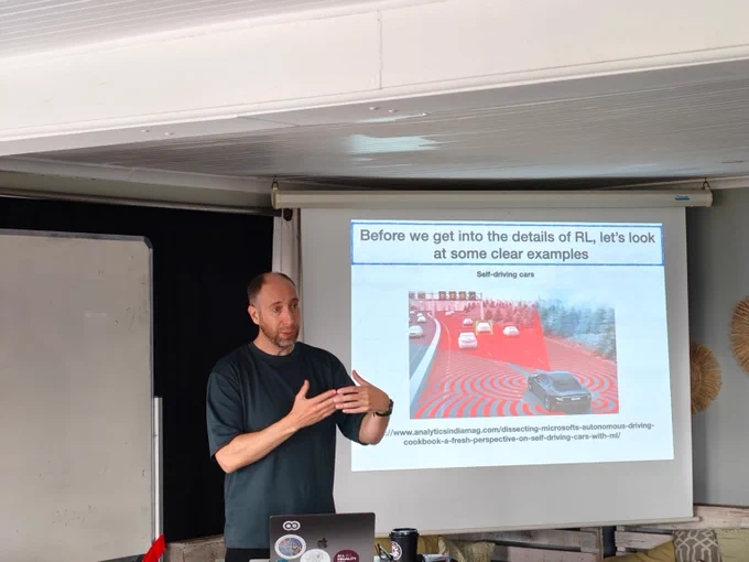 Jonathan Shock, during his talk, is giving examples where RL has been used.