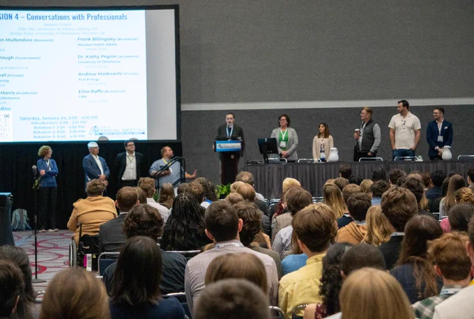 Panelists standing in front of the session room giving introductions.
