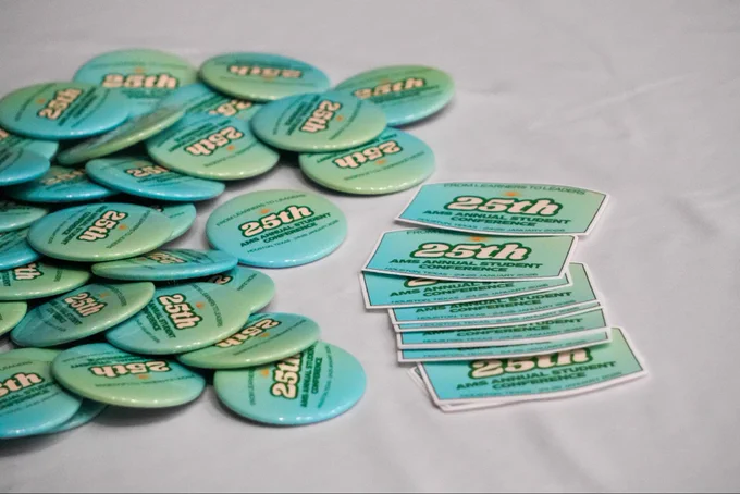 The 25th AMS Annual Student Conference anniversary pins and stickers.