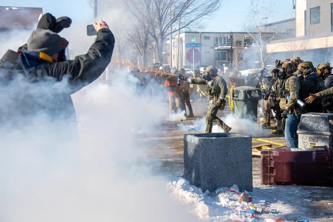 Protesters clash with law enforcement after a federal agent shot and killed a man on Jan. 24 in Minneapolis (Photo by Arthur Maiorella/Anadolu via Getty Images)
