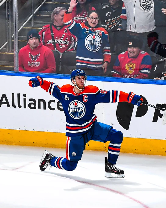 A photo of Connor McDavid on ice in an Oilers uniform celebrating after a goal.