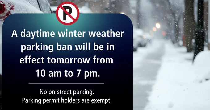 Background photo of cars parked on a snowy street. In foreground, a text box with a no-parking symbol and text "A daytime winter weather parking ban will be in effect tomorrow from 10 am to 7 pm. No on-street parking. Parking permit holders are exempt."