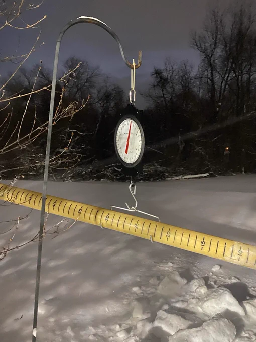 Picture of taking a snow core sample at our office.