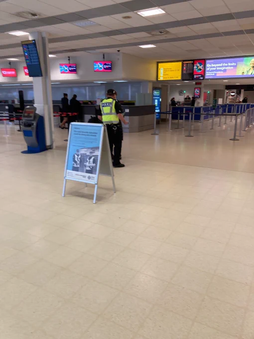 Police engaging with public by a servator message board