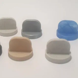 colorful 3D-printed plastic buttons designed as easy-to-handle game tokens.
