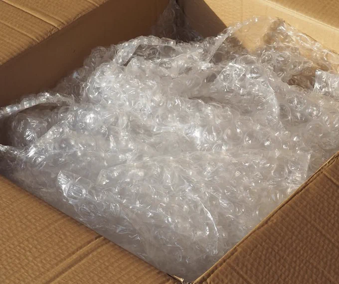 Bubble wrap inside an open cardboard box.