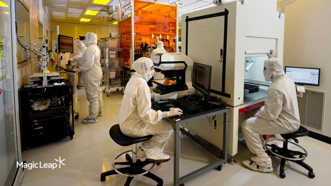 A group of Magic Leap technicians work in a clean room, conducting quality control tests on waveguide wafers.