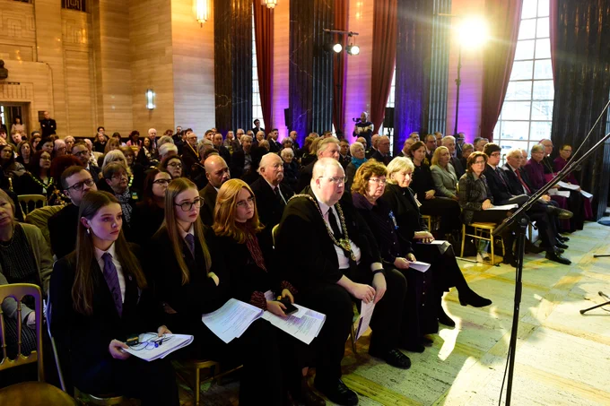A packed audience of attendees including the First Minister and Lord Mayor of Cardiff listen attentively to the testimony of Holocaust Survivor Peter Lantos BEM.