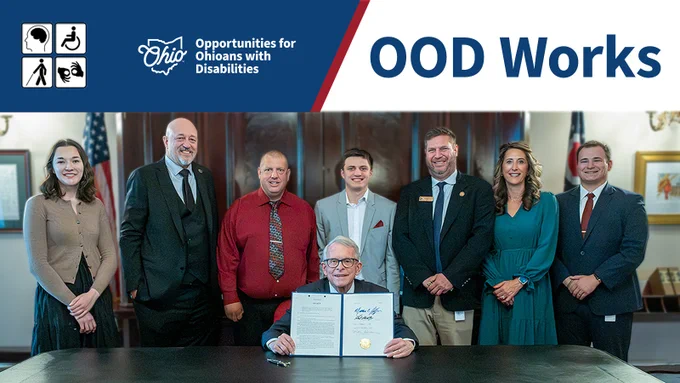 Pictured from left to right: Janae Myers, Legislative Aide for Rep. Click; Rep. Gary Click; Keith Jesse, proponent for the bill and for whom Keith’s Law is named; Governor DeWine; Brendan Garret, proponent for the bill; Rep. Brian Lorenz; Julia Garrett, proponent for the bill; and Ben Nettles, Former Legislative Aide for Rep. Click. Text, "OOD Works." OOD logo.