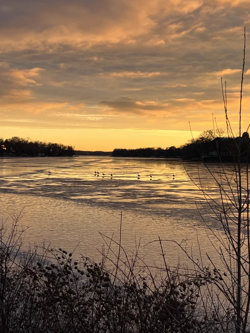 A yellow and orange sunset over a frozen river