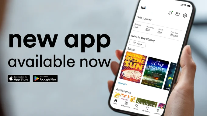 Hand holding a smartphone displaying a library app interface with book and audiobook options, promoting a new app available now.
