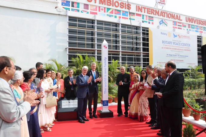 Group of individuals participating in a ceremonial event at Symbiosis International University