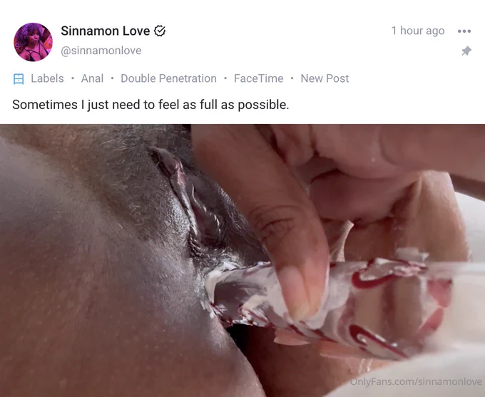 A close up of the author’s pussy with a creamy glass dildo with red hearts firmly planted in her ass.
