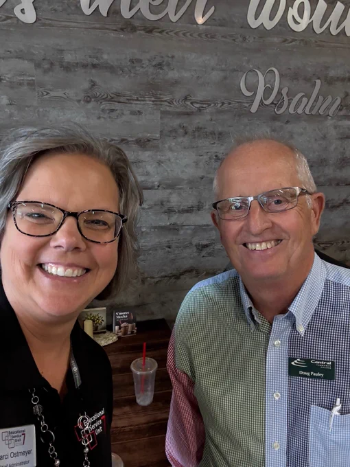 ESU 7 Chief Administrator with a board member. 