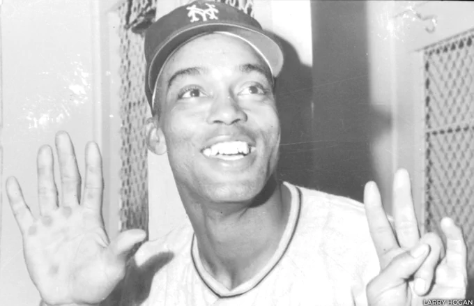 Monte Irvin holds up seven fingers and smiles while wearing a New York Giants cap. (Larry Hogan)