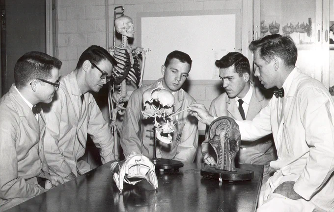 faculty member (Henry Hoffman) with students in a lab