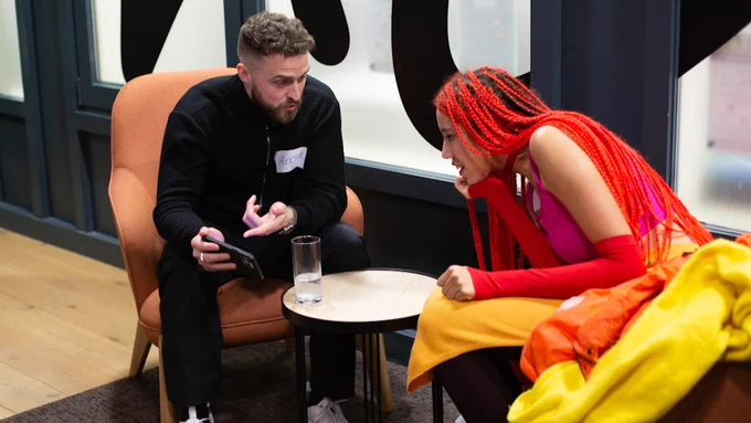 Two people sitting and talking.