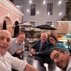 Dr. Licht and four researchers pose for a selfie in a restaurant.