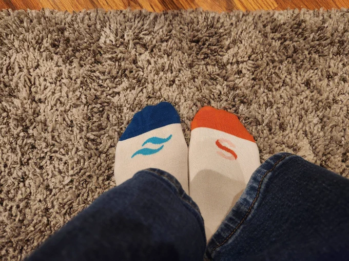 Kent's feet in Tailwind and Sanity branded socks
