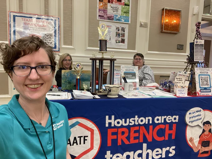 Hope in front of the Houston area French teachers AATF booth