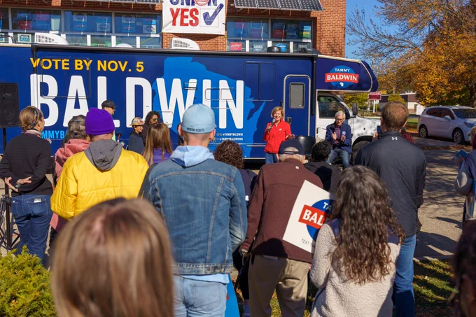 Supporters look on while Tammy Baldwin speaks at a rally. 