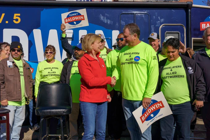 Tammy Baldwin shakes hands with a supporter.