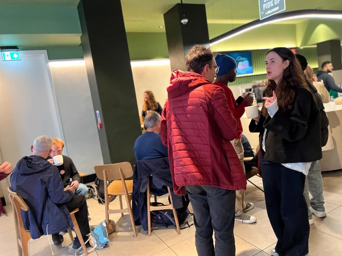 Picture of inside of Starbucks with people who stammer chatting.