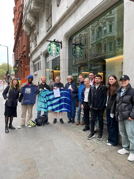 People who stammer gather outside starbucks with the stammering pride flag