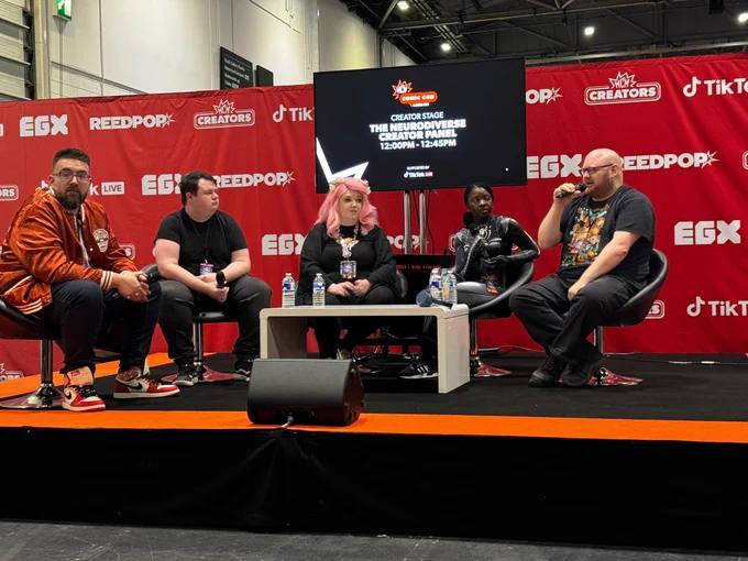 The panel sat around a table answering audience questions