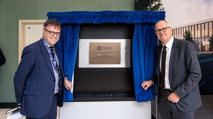 Dr Michael Cuthbert, Director of NQCC, and Lord Vallance stand next to NQCC's newly unveiled plaque