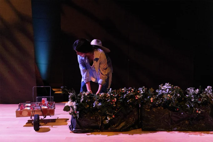 An actor on stage picking strawberries
