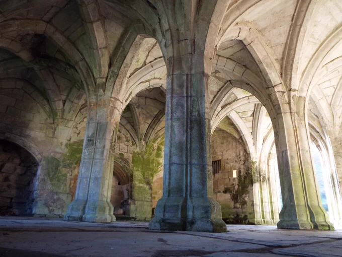 Image of interior pointed up from the floor to ceiling perspective in Valle Crucis Abbey