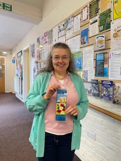 Donna holding her prize winning bookmark entry