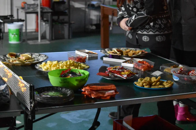 Various snacks laid out on a table tennis table.