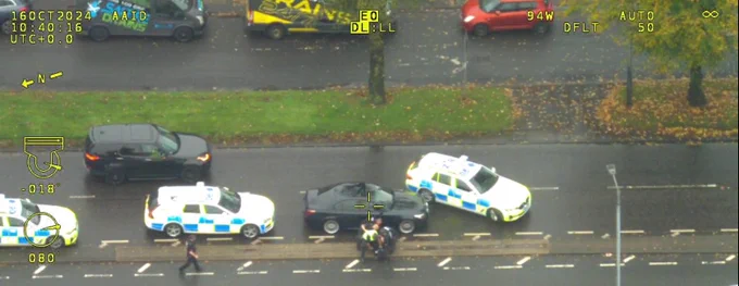 Image of polce vehicles surrounding offending vehicle.