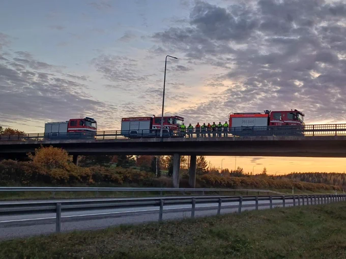 Paloautoja ja pelastajia iltavalossa sillalla.