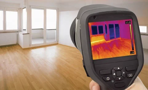 Heat-sensing equipment takes a reading of energy in a room