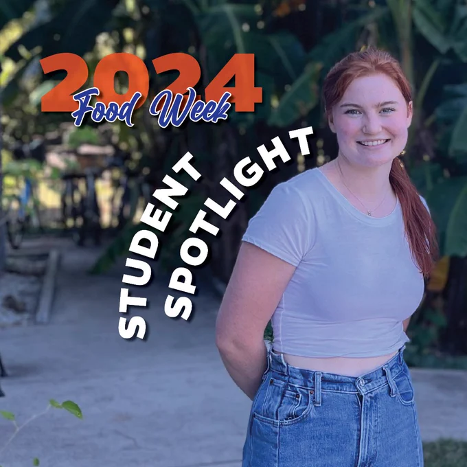 "2024 Food Week"
"Student Spotlight"

A young woman with red hair smiles for a picture in front of a bike rack and some trees.