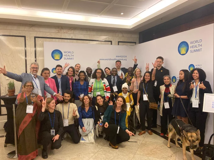 Picture of the participants, speakers and organisers that took part in the Side event at the World Health Summit: Health Equity for Persons with Disabilities to Achieve Health for All. They form a group of around 30 people, all smiling.