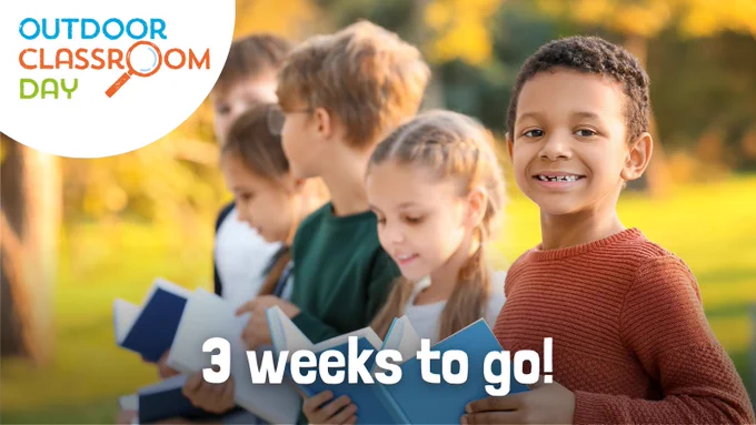A graphic featuring an image of children lined up outdoors as they recite from their books. The words '3 weeks to go!' are written in white along the bottom of the image, and the Outdoor Classroom Day logo is overlaid in the top left corner.
