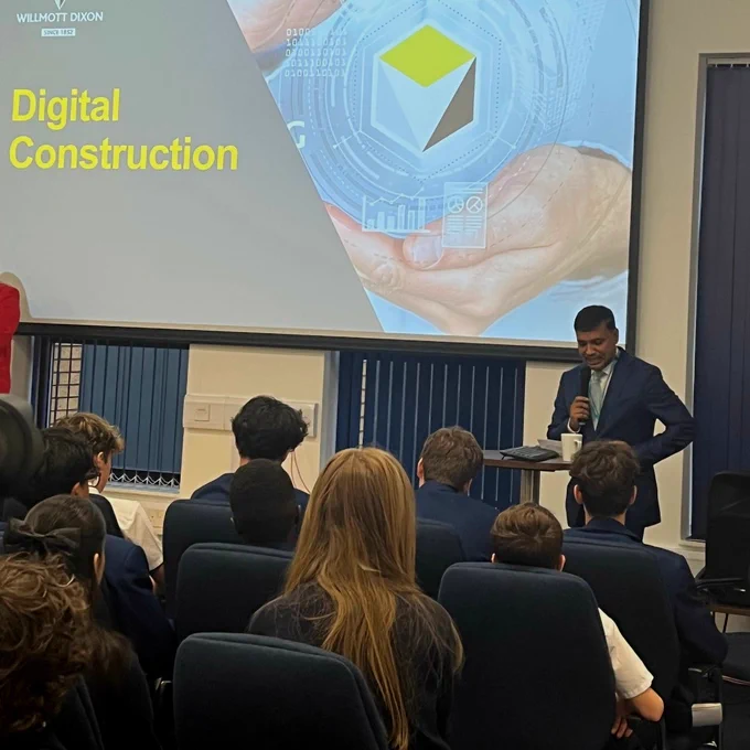 Cllr Mohon Ali delivers a talk to an audience of pupils