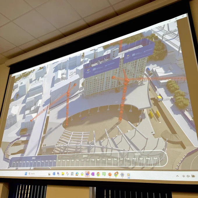 A screen displaying digital imagery of a building site.