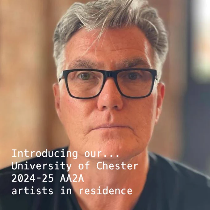 colour photo of photographer Tony Hayes, face and shoulders, short grey hair, glasses, blurred background