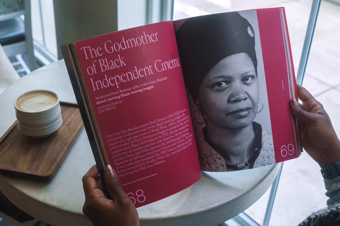 A  photo of the journal opened to a spread with a photo of Pearl Browser and the text “The Godmother of Black Independent Cinema.”