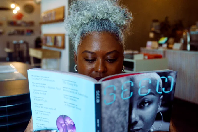 A photo of Swabreen Bakr reading a copy of Seen Issue 007. 