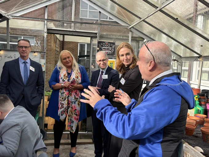 Viewing the greenhouse at Blessed Trinity. Representatives from DE NI, DfE and Education Scotland talking to teachers.