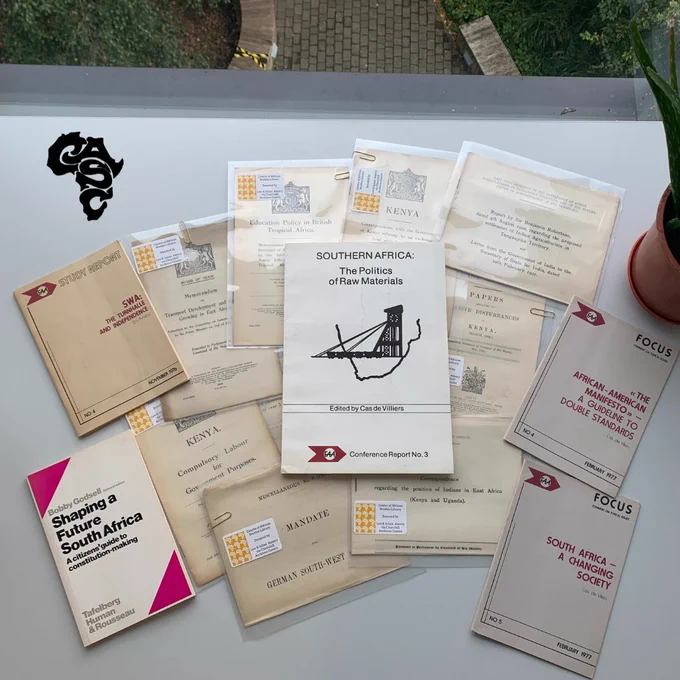Pamphlets donated by Leo and Julian Amery sprawled out on a desk in the African Studies Library.