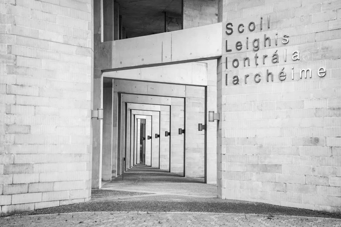 A concrete building with many pillars that narrow as they move off into the distance